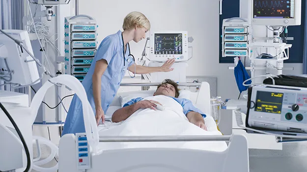 nurse tending patient in intensive care