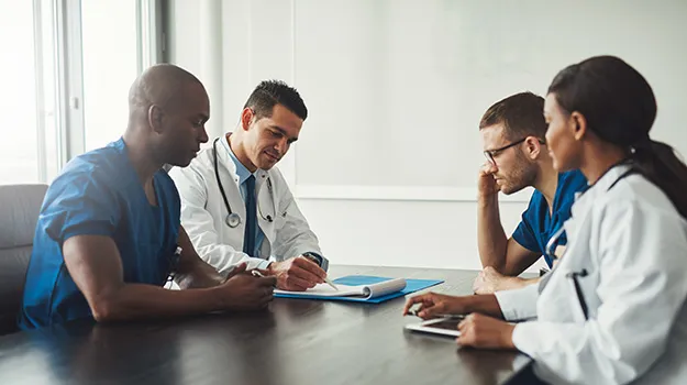 Multiracial medical team having a meeting with doc