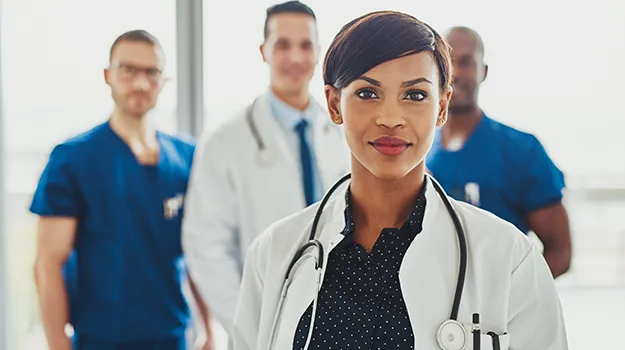 confident female doctor in front of team