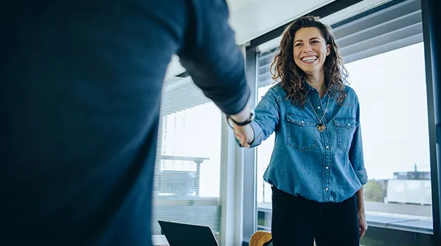 woman shaking hands with a job applicant