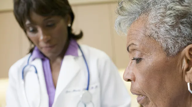 African female doctor with senior patient